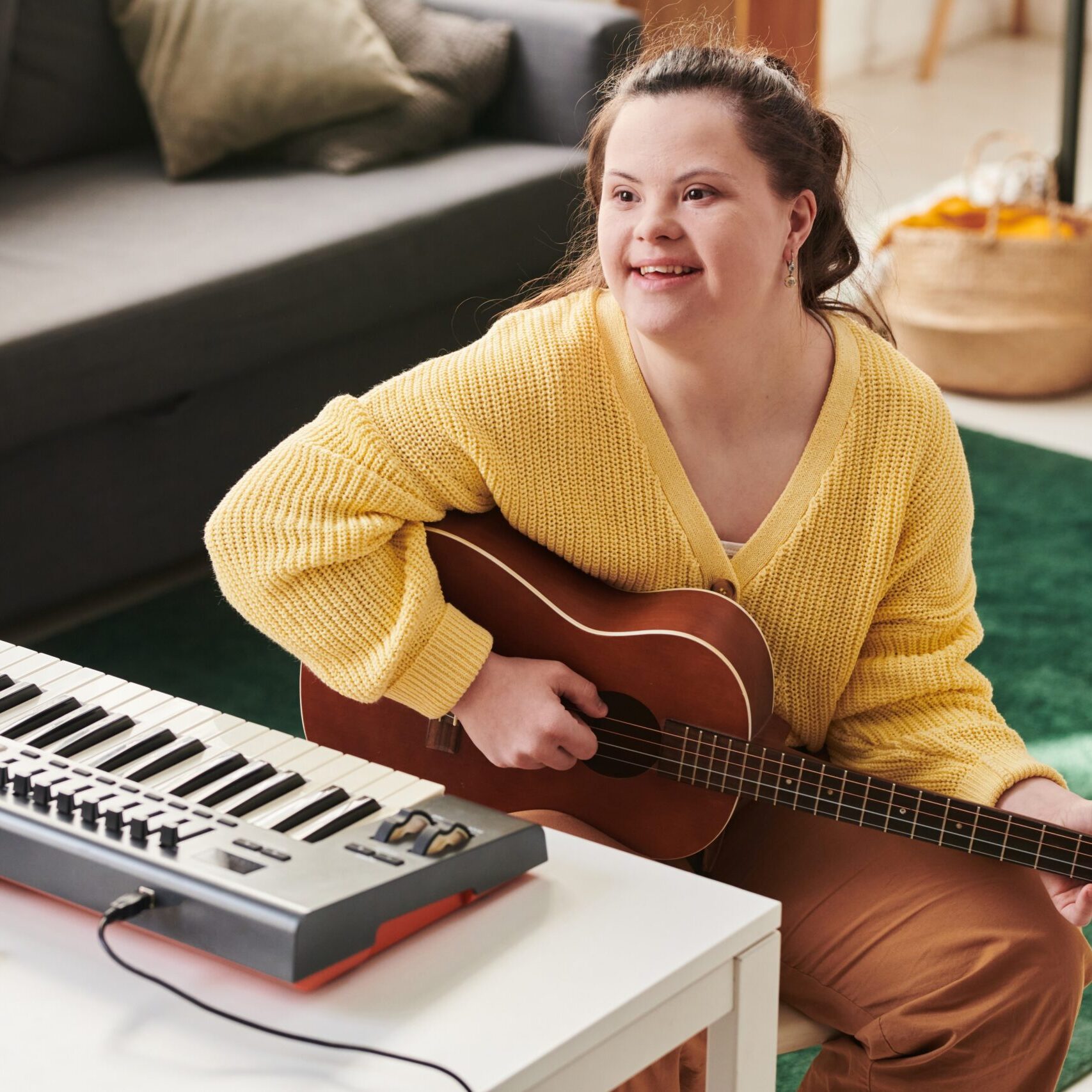 cheerful-girl-with-down-syndrome-playing-guitar
